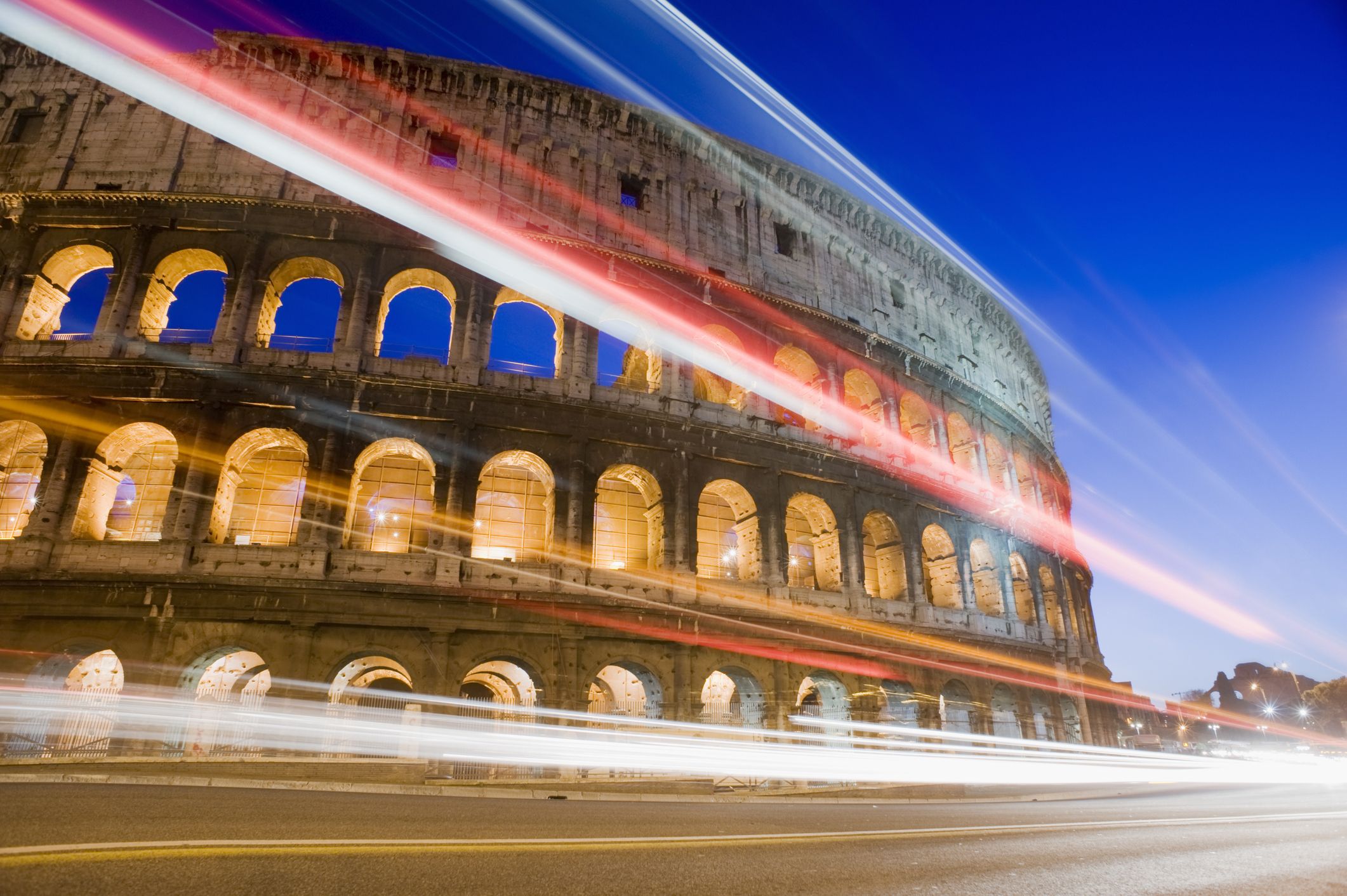 The Colosseum at night with car light trails, Rome, Italy